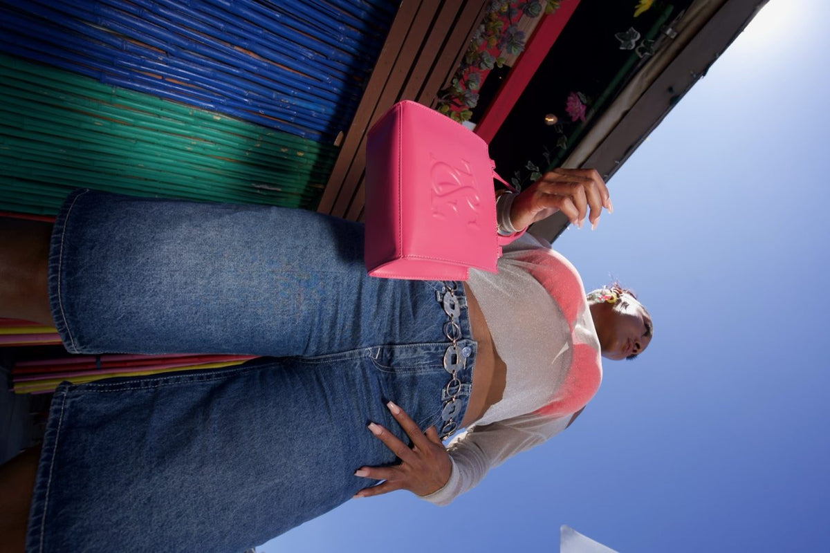 Essential Mini Tote in Raspberry carried on the boardwalk