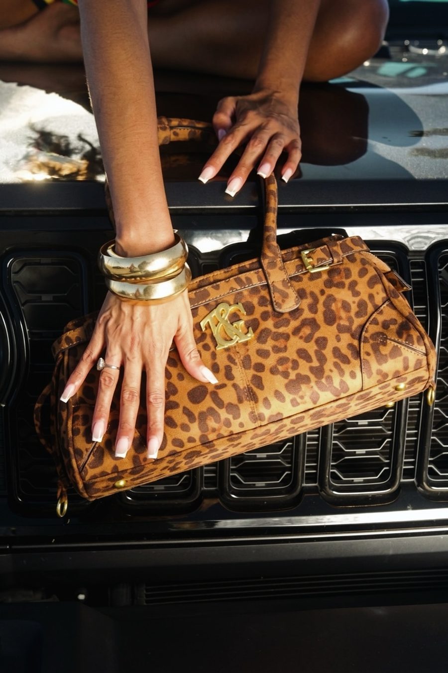 Bonita Baguette Bag in Cheetah Print on a car hood