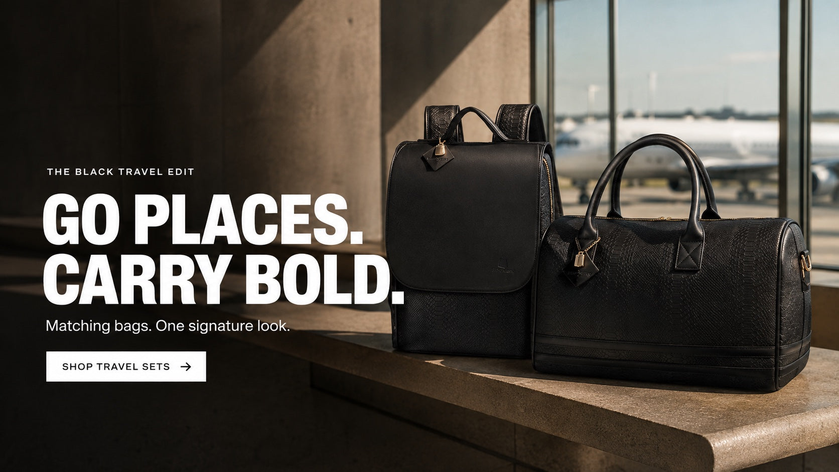 The Black Travel Edit. Go places. Carry bold. Matching bags. One signature look. Shop travel sets. Black backpack and duffle in a sunlit airport lounge.